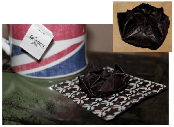  Make a Sherlock Black Lotus pin by using dark paper with and origami "lotus blossom" pattern.