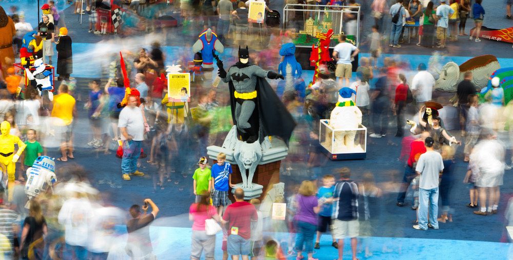 Image of the LEGO Model Museum. Some motion blur highlights the activity and a life sized Batman is featured at the center of the image
