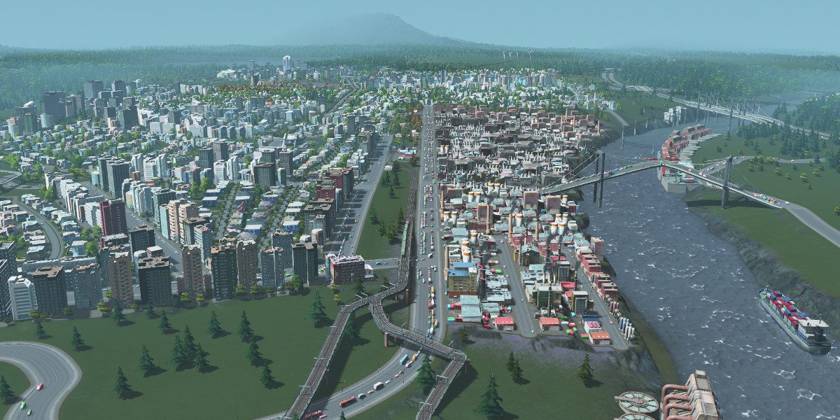 Shot of a city showing river, industrial section, and nearby commercial/residential district.