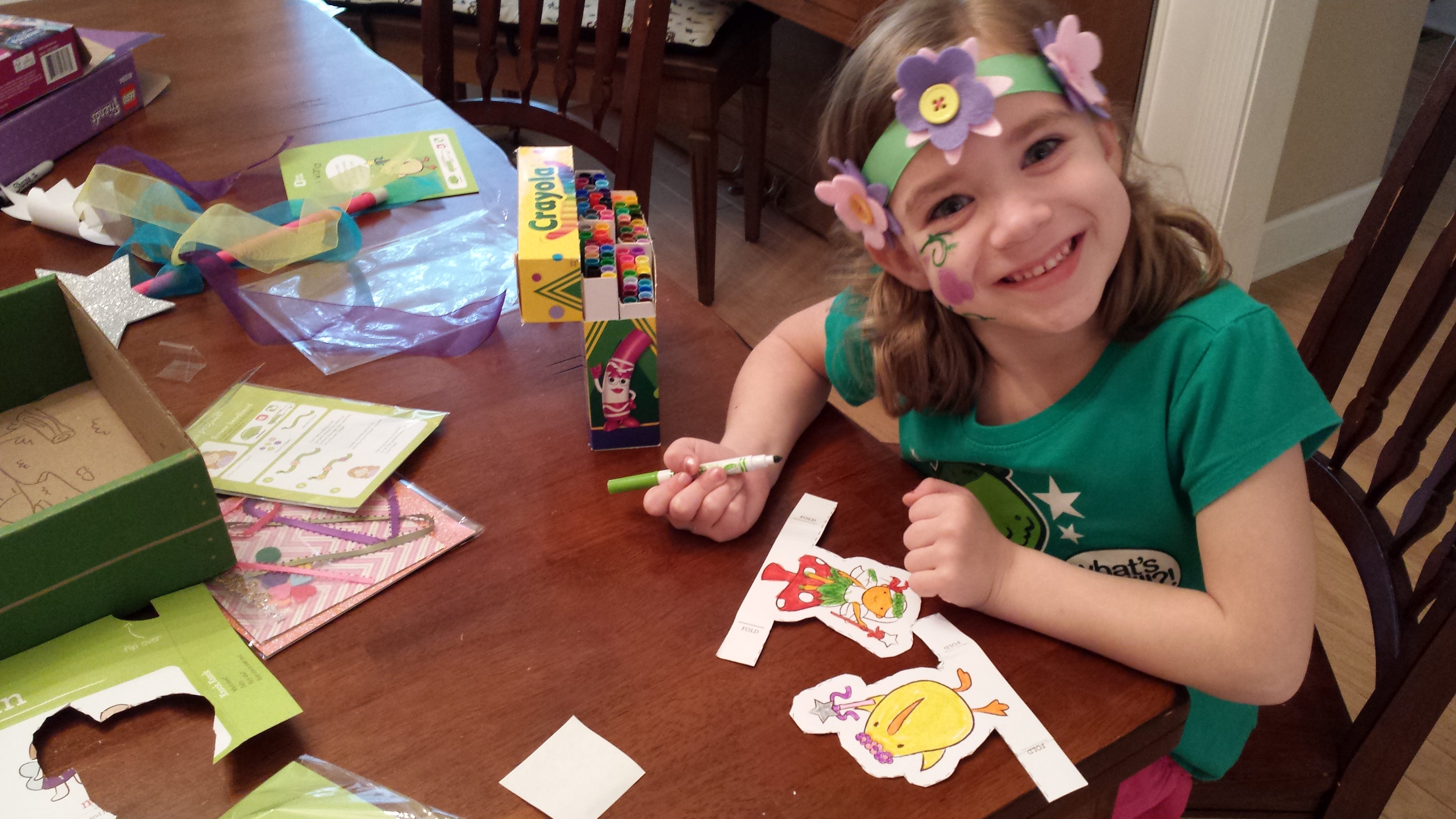 A young girl completes Kiwi Crate activities