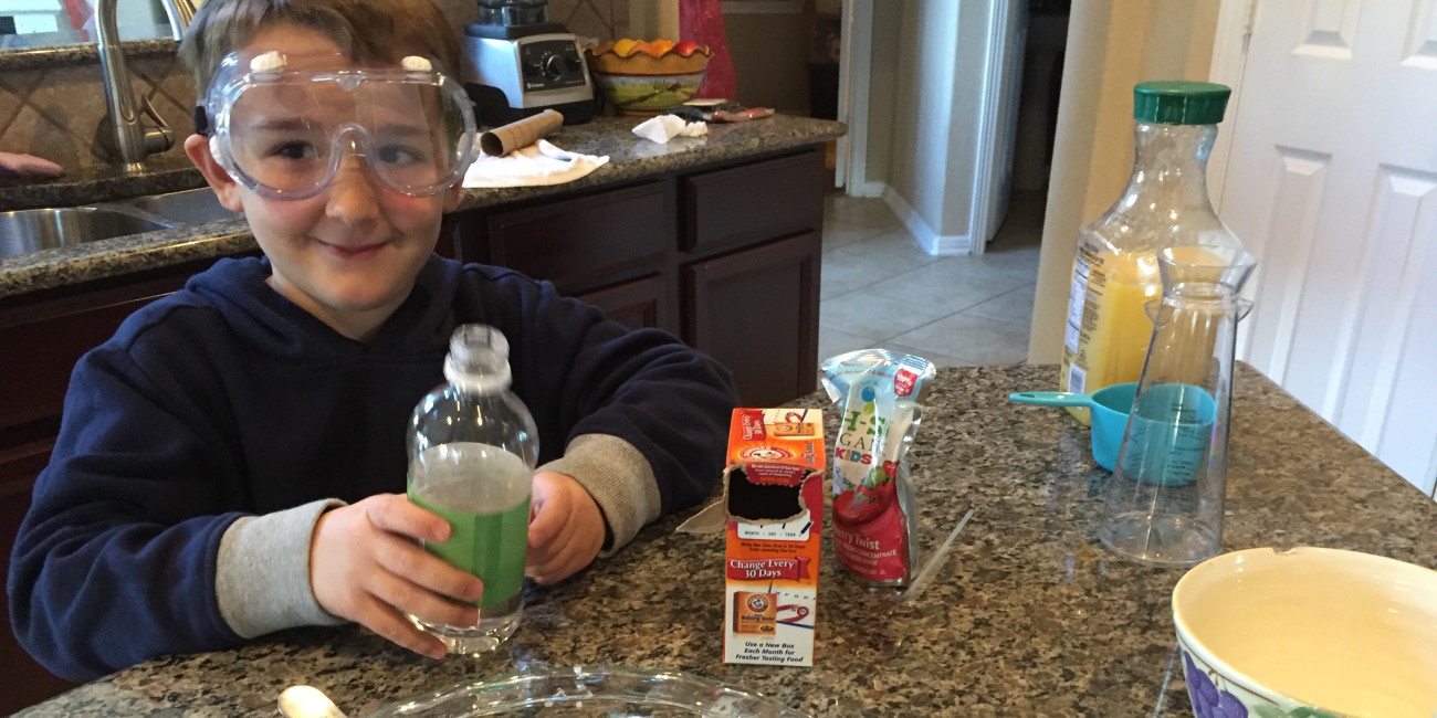 Child with ingredients for science fair project.
