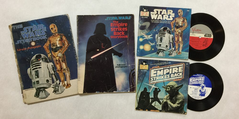 The full-color photograph books from 'Star Wars' and 'Empire Strikes Back' alongside the two read-along books, with 33 1/3 RPM records showing.