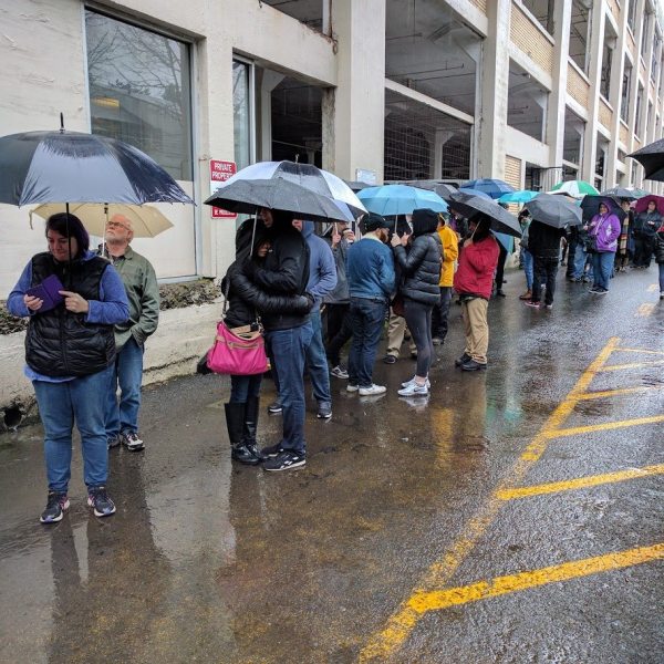 Crowd waits in rain