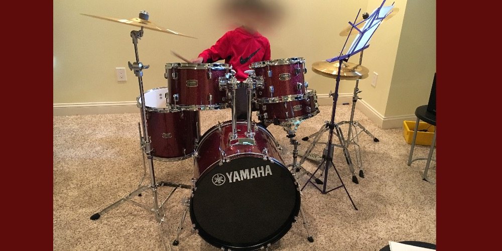 image of kid playing Yamaha Rydeen drum kit