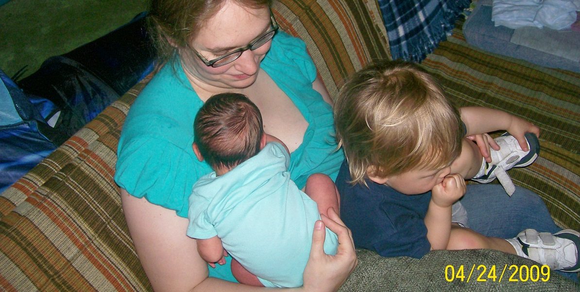 mom juggles two small children on her lap