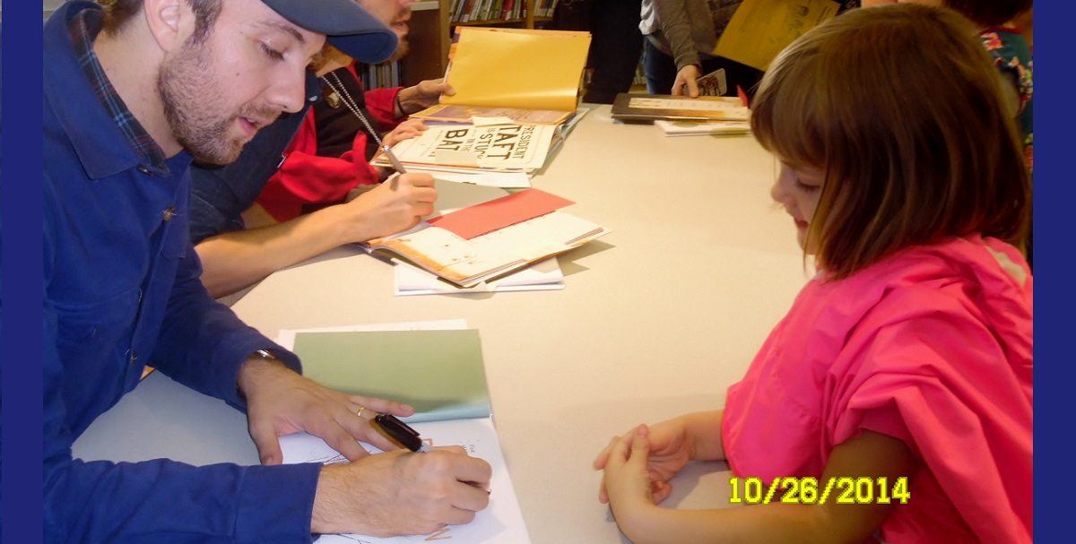 Jon Klassen signs a book for a five year old girl
