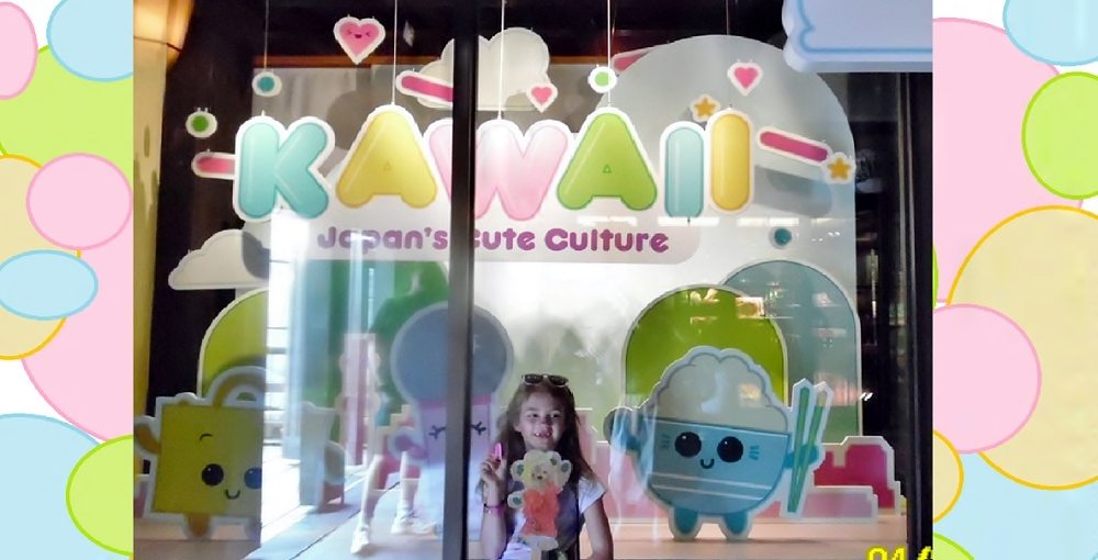 Child in front of window display reading "KAWAII: Japan's Cute Culture" at EPCOT