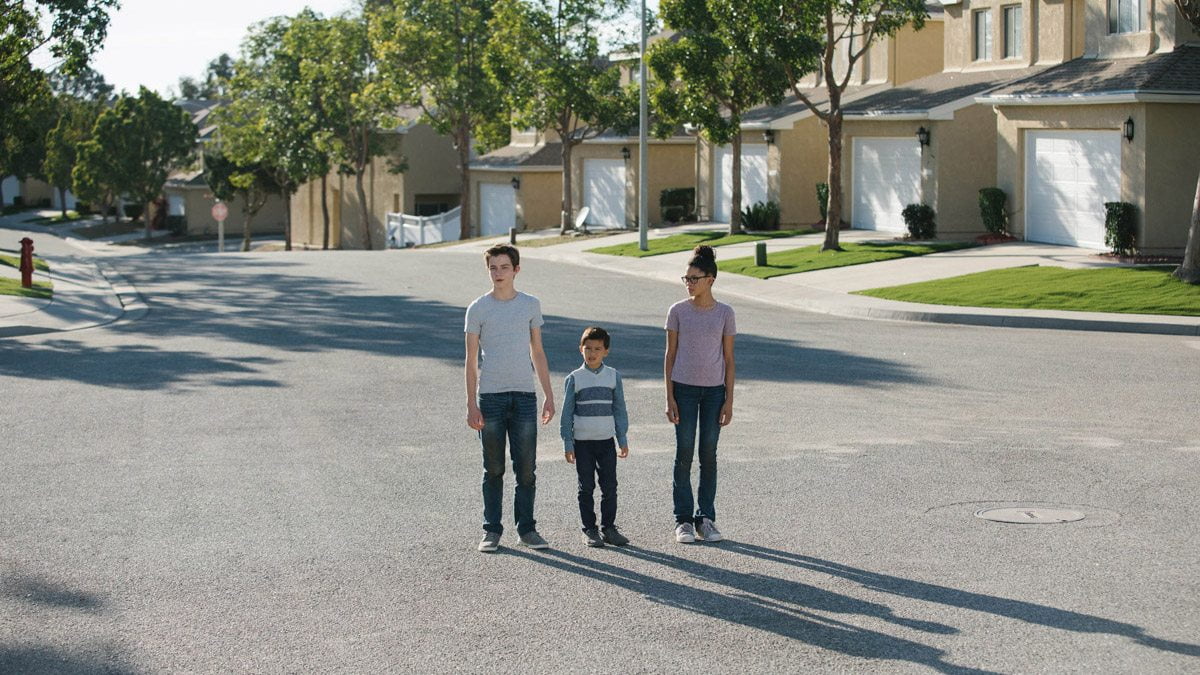 Calvin, Charles Wallace and Meg on a creepy street in 'A Wrinkle in Time'.