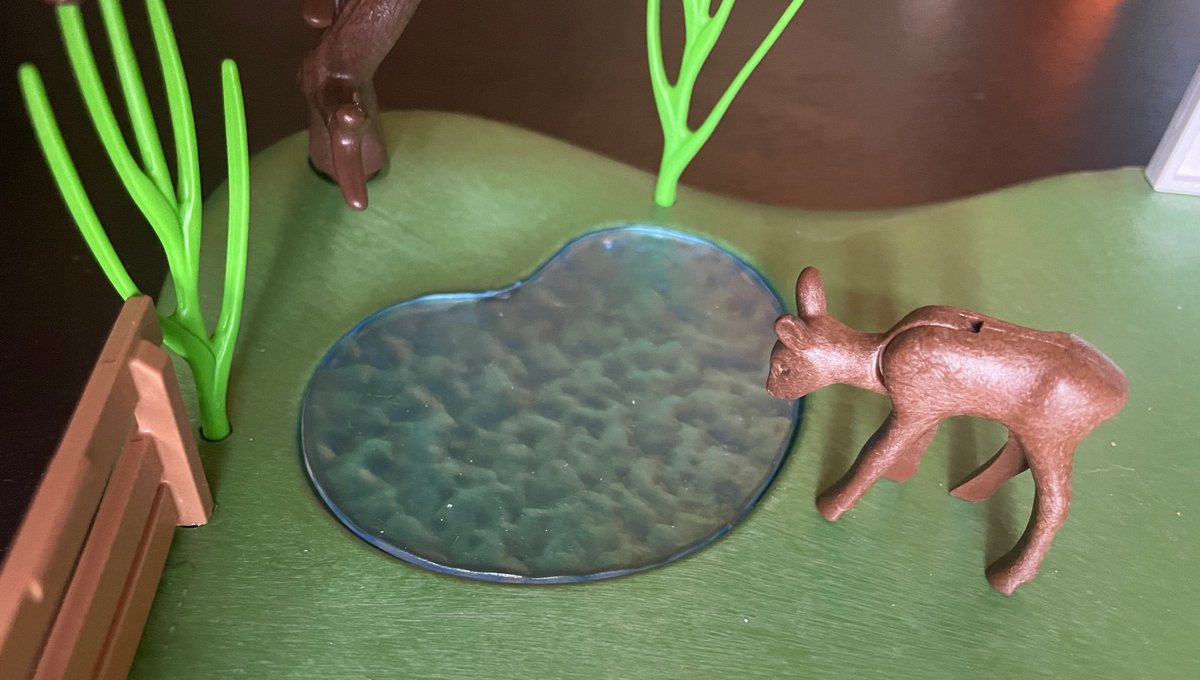 Close-up of fawn drinking from pond in Horse Ranch Playset.