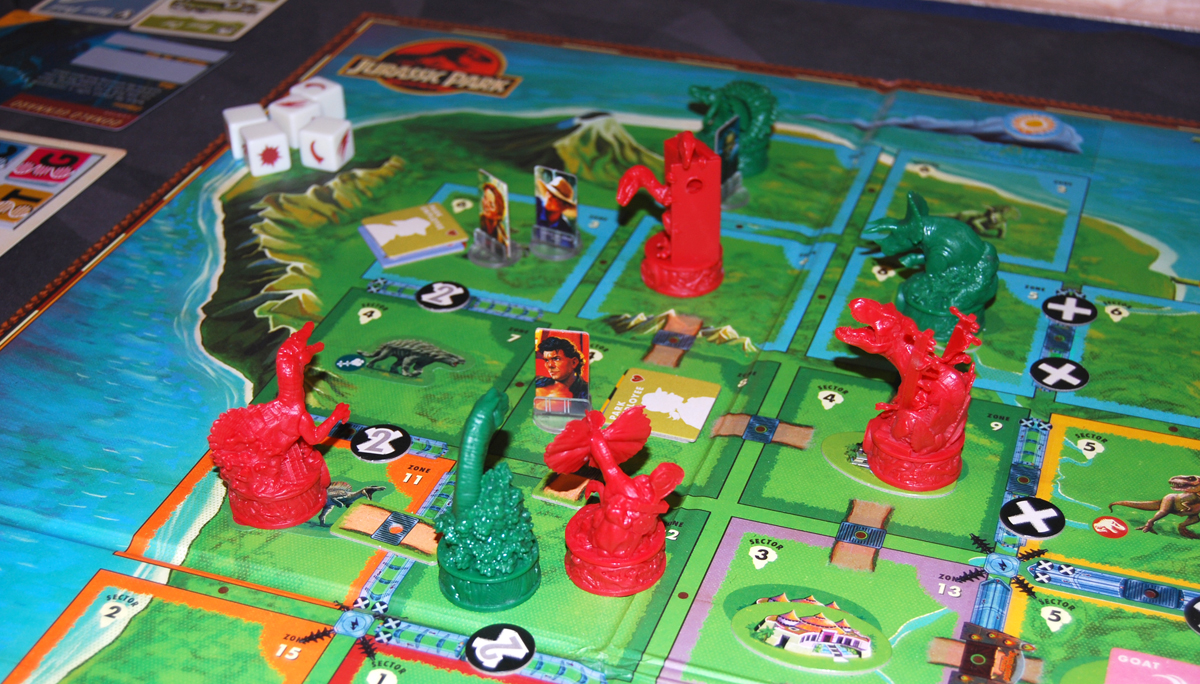 Jurassic World board game: several dinosaur figurines surround Ian Malcolm standee.