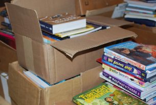 Stacks of boxes overflowing with books