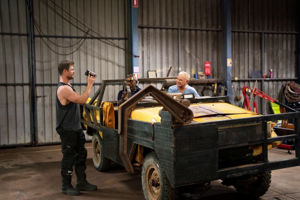 People next to vehicle